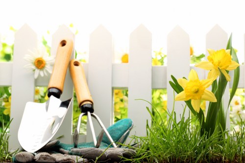 Gardening contractor inspecting a lawn with safety gear