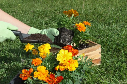Gardening operative wearing high-visibility PPE and boots
